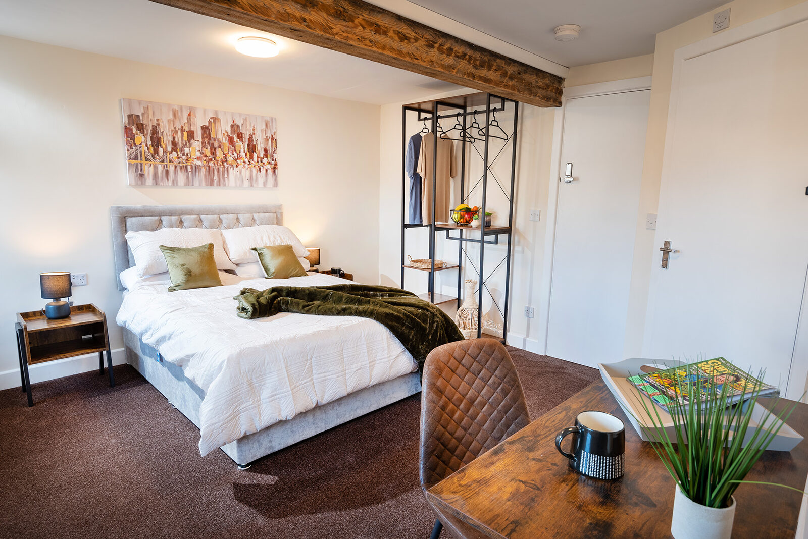 An ensuite bedroom with a king-size bed at Kensley Properties